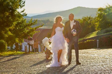 Tihany, Hungary - September 27, 2019: Photo shoot of a wedding couple near the castle. Shooting the bride and groom by a male photographer on their wedding dayのeditorial素材