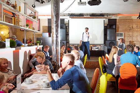 Kirov, Russia - October, 2019: People at table in small cafe or restaurant during intellectual game. People waiting for the waiter to get the menu or foodのeditorial素材