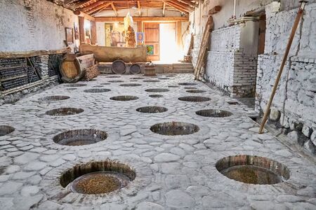 Making wine at traditional Georgian technology in large clay jugs kvevri, buried in the ground. Plant of Kindzmarauli Corporationの写真素材