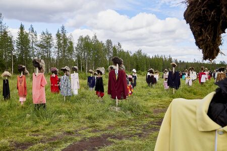 SUOMUSSALMI, FINLAND - JULY 24, 2019: View to the group of objects in people clothes which looks like crowd in the field in a summer or autumn day. Finland. Installation Reijo Kela Silent Peopleのeditorial素材