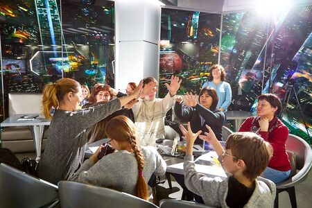 Kirov, Russia - September 25, 2019: People at table in small cafe or restaurant during intellectual game. Hungry group waiting for the waiter to get the menu or foodのeditorial素材