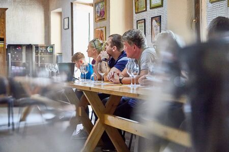 Kvareli, Georgia - October20, 2019: People at the table and glasses during a wine tasting at the...