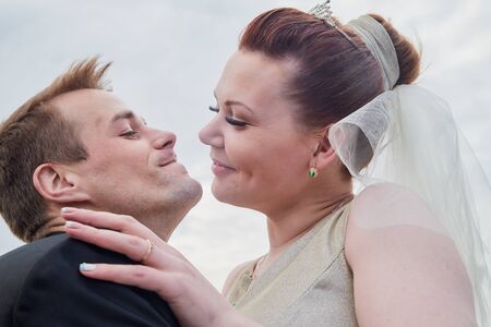 Murmansk, Russia - June 21, 2019: Close up emotional portrait of bride and groom outdoors in a cloudy dayのeditorial素材
