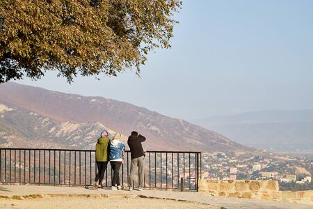 Mtskheta, Georgia - October 25, 2019: Tourist on the observation deck in the mountains in a summer...