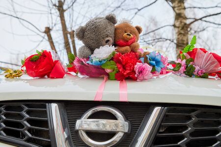 Kirov, Russia - March 22, 2019: Wedding decoration on the car with ribbons, flowers and toys before marriage ceremony in Russia in a dayのeditorial素材