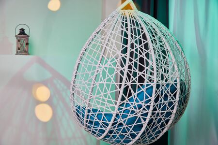 Hanging wicker chairs for relax time in the room. Place for photoshoot in studio. Background indoorsの写真素材