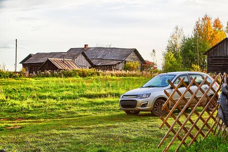 Village nature landscape with houses and green field of grass on a evening, day or morning in a summer or autumn timeの写真素材