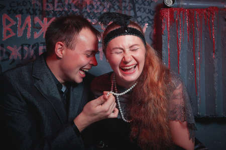 Kirov, Russia - October 05, 2019: Couple including girl and guy in a prison cell during a date. Photoshoot in gangsters retro Chicago styleのeditorial素材