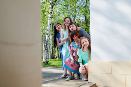Group of female friends walking in summer or spring park. Women and adult girl have fun together outdoorのeditorial素材