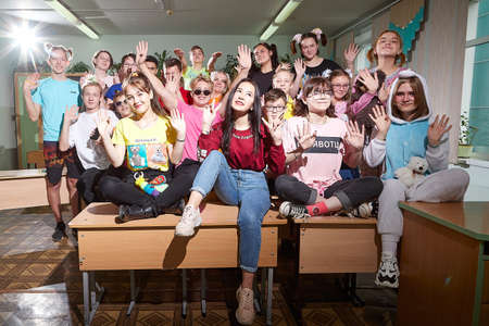 Kirov, Russia - September 28, 2019: Big group of students or schoolchildren in funny dress in classroom. Teenagers posing togetherのeditorial素材