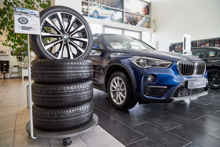Petrozavodsk, Russia - June 19, 2019: Tires and wheels in showroom with cars of dealership BMW in Petrozavodsk city in Russiaのeditorial素材