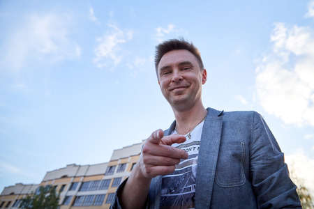 Kirov, Russia - September 04, 2019: Portrait of a handsome fun smiling young man outdoors in the street of the city in a summer, spring or autumn dayのeditorial素材