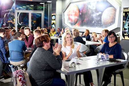 Kirov, Russia - September 25, 2019: People at table in small cafe or restaurant during intellectual...