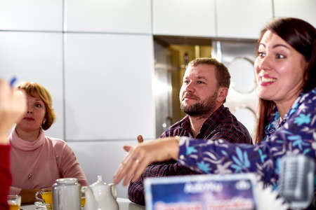 Kirov, Russia - September 25, 2019: People at table in small cafe or restaurant during intellectual game. Hungry group waiting for the waiter to get the menu or foodのeditorial素材