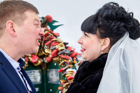 Kirov, Russia - March 22, 2019: Bride and groom holding the lock on the wedding day during the marriage in a winter dayのeditorial素材