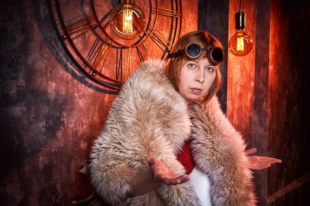 Ugly strange girl in unusual glasses in a strange dark room with a clock on the wall and the light of lamps. Cosplay photoshoot in the Studio. Apocalypseの写真素材