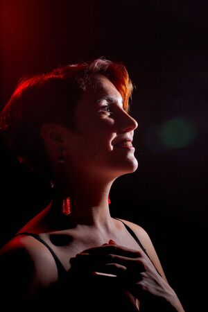 Portrait of a beautiful , charming young woman in a red and black t -shirt or a combination with...