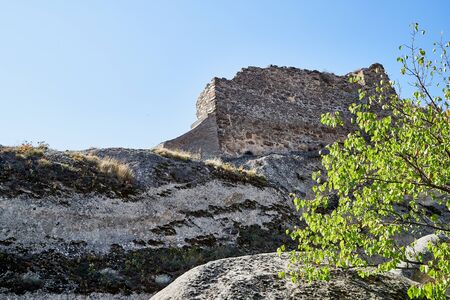 View of Antique cave city with old houses, rocks and grey stones in a sunny day with blue sky. Uplistsikhe old city, Georgia, Europeの写真素材