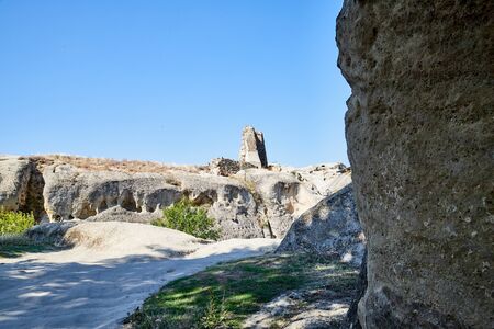 View of Antique cave city with old houses, rocks and grey stones in a sunny day with blue sky. Uplistsikhe old city, Georgia, Europeの写真素材