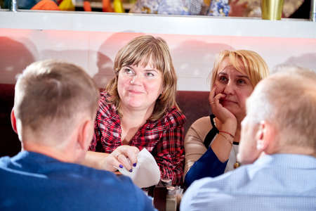 Kirov, Russia - October, 2019: People at table in small cafe or restaurant during intellectual game. People waiting for the waiter to get the menu or foodのeditorial素材
