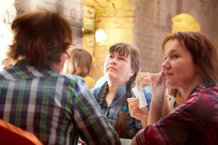 Kirov, Russia - October, 2019: People at table in small cafe or restaurant during intellectual game. People waiting for the waiter to get the menu or foodのeditorial素材