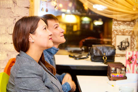 Kirov, Russia - September 17, 2019: People at table in small cafe or restaurant during intellectual game. Hungry group waiting for the waiter to get the menu or foodのeditorial素材