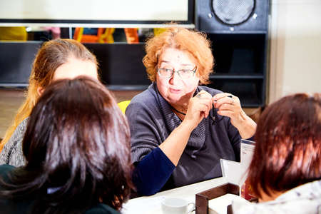 Kirov, Russia - September 17, 2019: People at table in small cafe or restaurant during intellectual game. Hungry group waiting for the waiter to get the menu or foodのeditorial素材