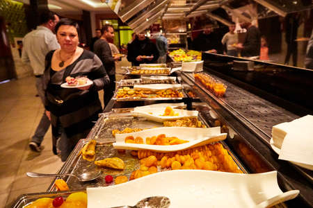 Antalia, Turkey - December 12, 2019: Food on the shelves in the self-service buffet with all inclusive and people in the hotel in Turkeyのeditorial素材