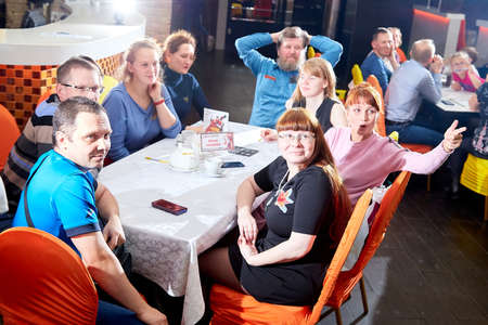 Kirov, Russia - October, 2019: People at table in small cafe or restaurant during intellectual game. People waiting for the waiter to get the menu or foodのeditorial素材