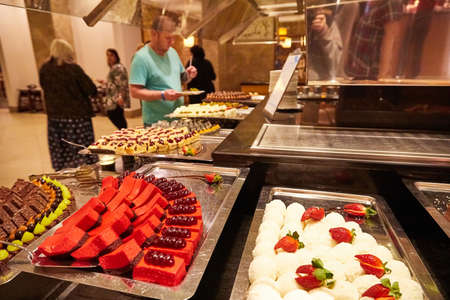 Food in the bowl in the self-service buffet with all inclusive in the hotel in Turkey. Many options for sweet dishes and cakesのeditorial素材