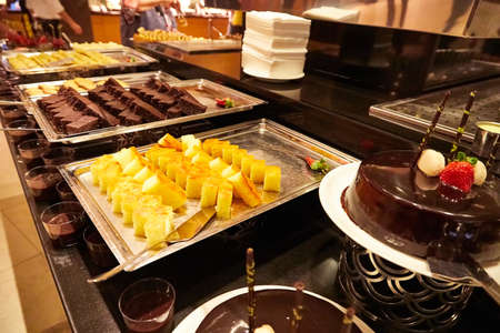 Food in the bowl in the self-service buffet with all inclusive in the hotel in Turkey. Many options for sweet dishes and cakesのeditorial素材