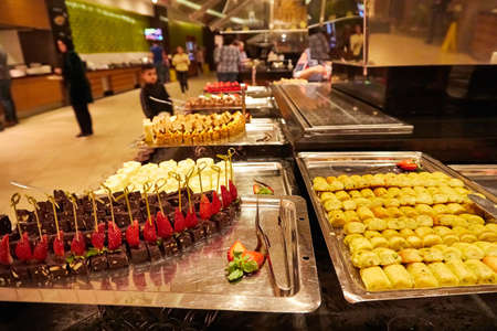 Food in the bowl in the self-service buffet with all inclusive in the hotel in Turkey. Many options for sweet dishes and cakesのeditorial素材