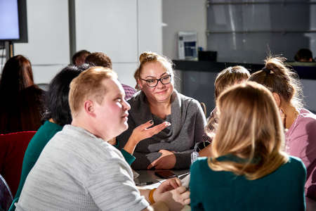 Kirov, Russia - September 25, 2019: People at table in small cafe or restaurant during intellectual game. Hungry group waiting for the waiter to get the menu or foodのeditorial素材