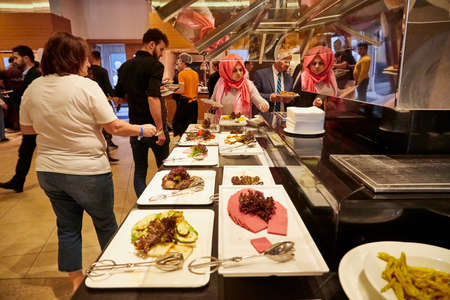 Antalia, Turkey - December 21, 2019: Food on the shelves in the self-service buffet with all inclusive and people in the hotel in Turkeyのeditorial素材
