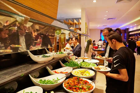 Antalia, Turkey - December 21, 2019: Food on the shelves in the self-service buffet with all inclusive and people in the hotel in Turkeyのeditorial素材