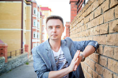 Kirov, Russia - September 04, 2019: Portrait of a handsome fun smiling young man outdoors in the street of the city in a summer, spring or autumn dayのeditorial素材