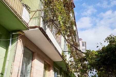 Balconies on the facade of a house in the city on a good dayの写真素材