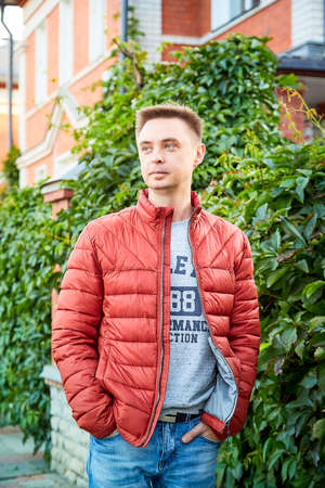 Kirov, Russia - September 04, 2019: Portrait of a handsome fun smiling young man outdoors in the street of the city in a summer, spring or autumn dayのeditorial素材