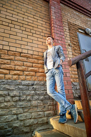 Kirov, Russia - September 04, 2019: Portrait of a handsome fun smiling young man outdoors in the street of the city in a summer, spring or autumn dayのeditorial素材