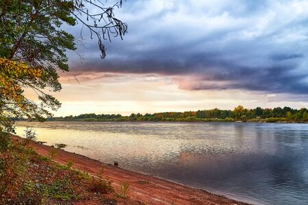 Beautiful summer landscape with river, bright blue sky and dramatic clouds in a summer, spring or...