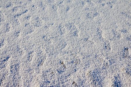 Snow or ice texture or background outdoors in a winter day. Nature landscape with frozen water on a...
