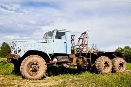 Dirty truck on a country green grass in a sunny summer day with blue skyの写真素材