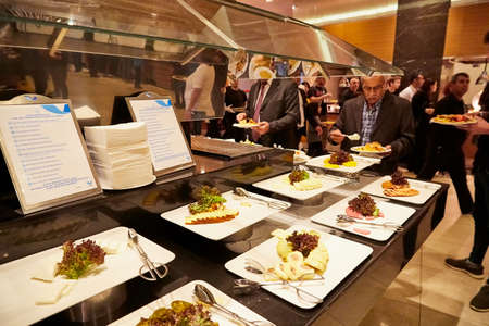 Antalia, Turkey - December 21, 2019: Food on the shelves in the self-service buffet with all inclusive and people in the hotel in Turkeyのeditorial素材