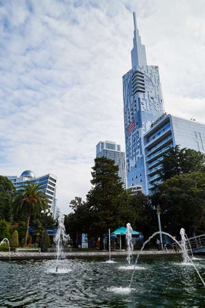 Batumi, Georgia - October 23, 2019: Part of city Batumi with houses, plant and blue sky with white...