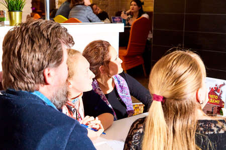 Kirov, Russia - September 17, 2019: People at table in small cafe or restaurant during intellectual...