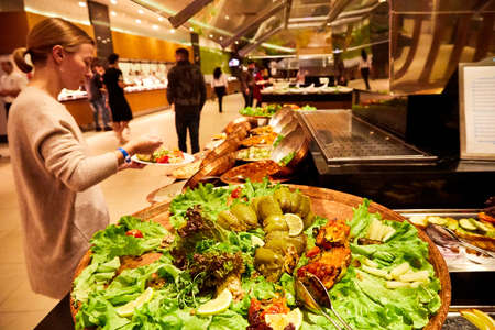 Antalia, Turkey - December 12, 2019: Food on the shelves in the self-service buffet with all inclusive and people in the hotel in Turkeyのeditorial素材