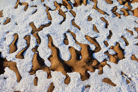 Testure or background with snow, ice and sand in a cold winter day outdoors. Nature landscape with...