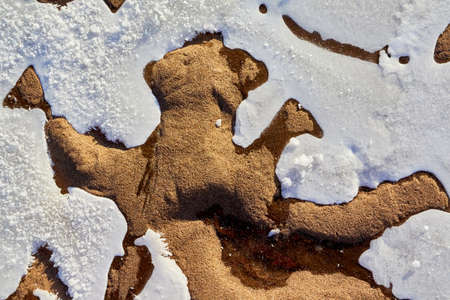 Testure or background with snow, ice and sand in a cold winter day outdoors. Nature landscape with...