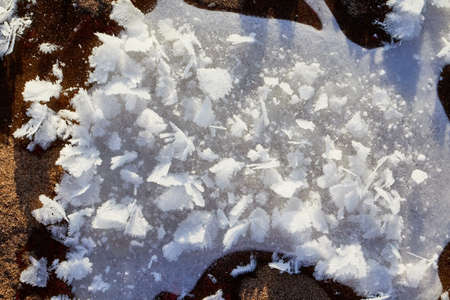 Testure or background with snow, ice and sand in a cold winter day outdoors. Nature landscape with...
