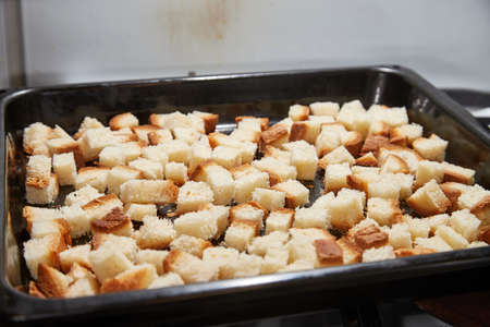 Square toasted pieces of homemade delicious rusk, hardtack, Dryasdust, zwieback on a baking sheet